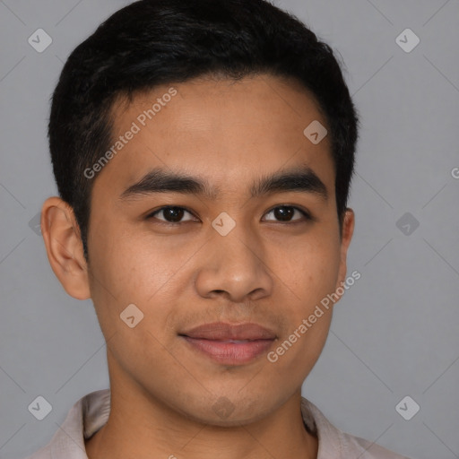 Joyful latino young-adult male with short  brown hair and brown eyes