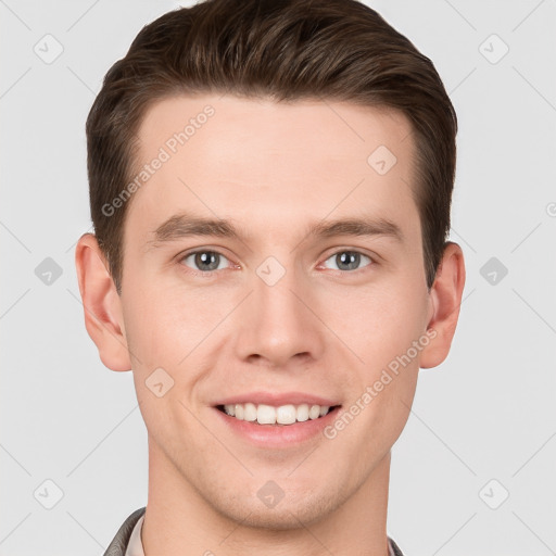 Joyful white young-adult male with short  brown hair and grey eyes