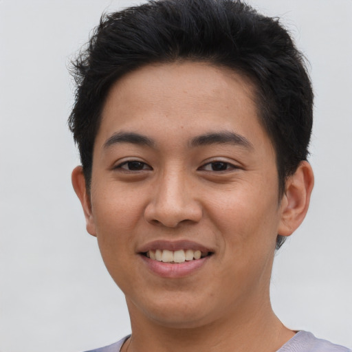 Joyful asian young-adult male with short  brown hair and brown eyes