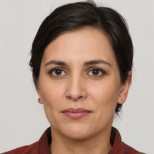 Joyful white adult female with medium  brown hair and brown eyes