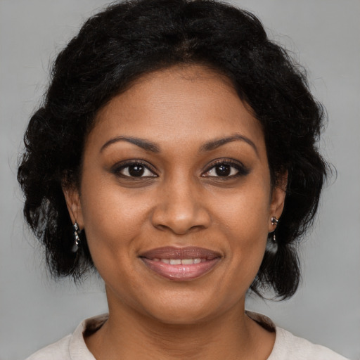 Joyful black young-adult female with medium  brown hair and brown eyes