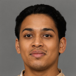 Joyful latino young-adult male with short  brown hair and brown eyes