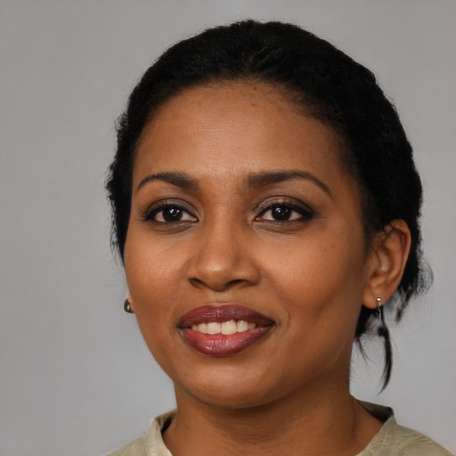 Joyful black young-adult female with medium  black hair and brown eyes