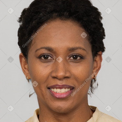 Joyful black adult female with short  brown hair and brown eyes