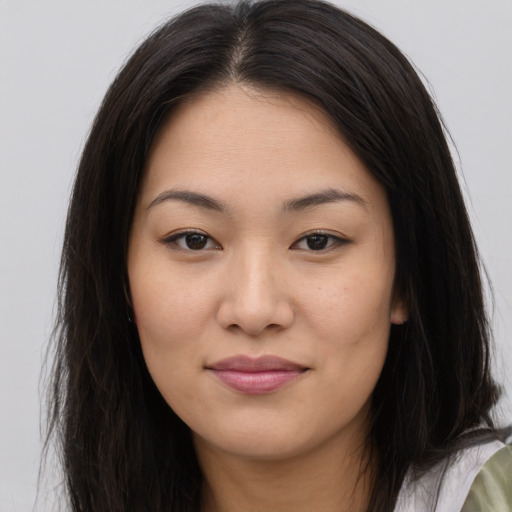 Joyful asian young-adult female with long  brown hair and brown eyes