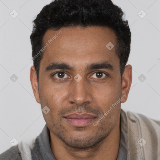 Joyful black young-adult male with short  brown hair and brown eyes