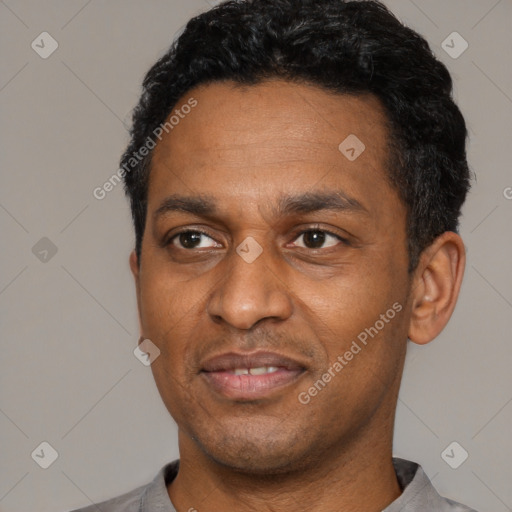 Joyful latino adult male with short  black hair and brown eyes