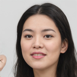 Joyful asian young-adult female with long  black hair and brown eyes