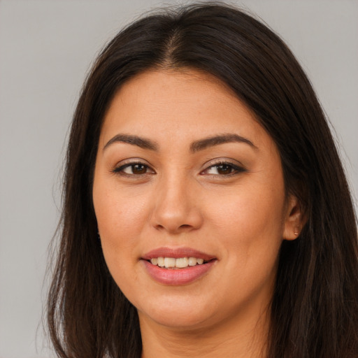 Joyful asian young-adult female with long  brown hair and brown eyes