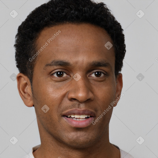 Joyful black young-adult male with short  brown hair and brown eyes
