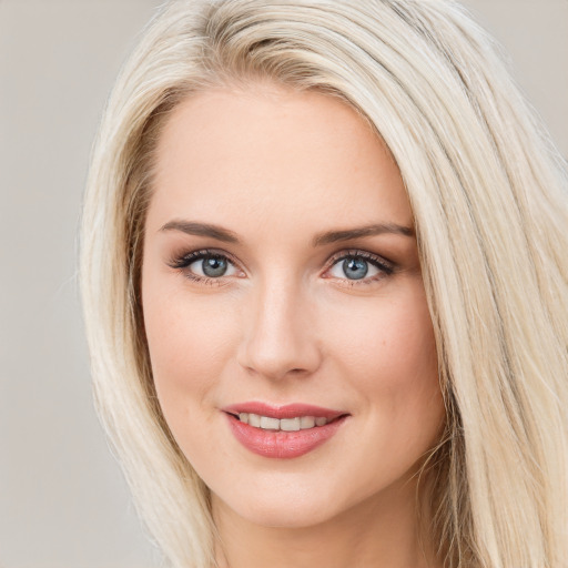 Joyful white young-adult female with long  brown hair and blue eyes