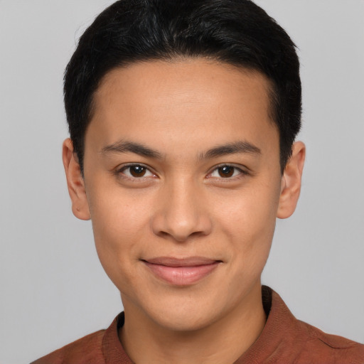 Joyful latino young-adult male with short  brown hair and brown eyes