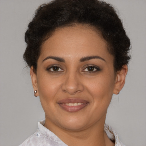 Joyful latino young-adult female with short  brown hair and brown eyes