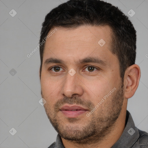 Joyful white adult male with short  black hair and brown eyes