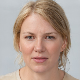 Joyful white adult female with medium  brown hair and blue eyes