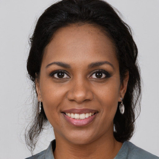 Joyful black young-adult female with medium  brown hair and brown eyes