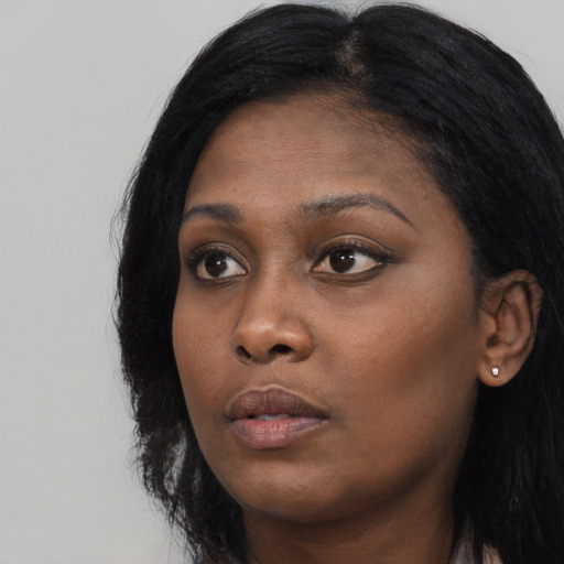 Neutral black young-adult female with long  black hair and brown eyes
