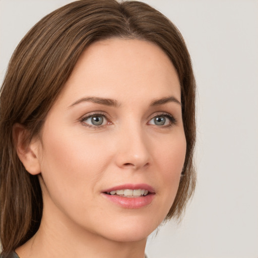 Joyful white young-adult female with medium  brown hair and green eyes