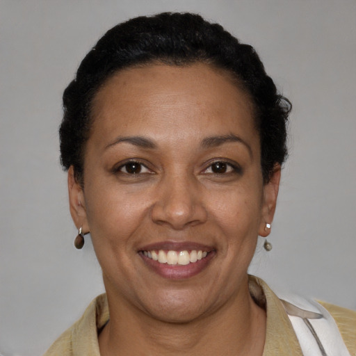 Joyful latino young-adult female with short  brown hair and brown eyes