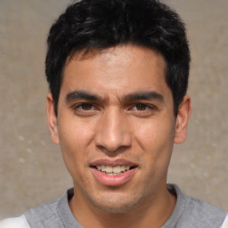 Joyful white young-adult male with short  black hair and brown eyes