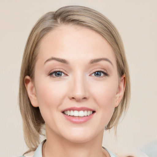 Joyful white young-adult female with medium  brown hair and blue eyes