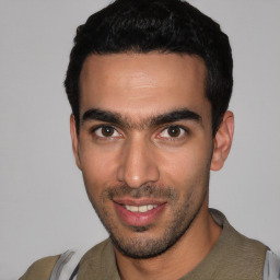 Joyful white young-adult male with short  black hair and brown eyes