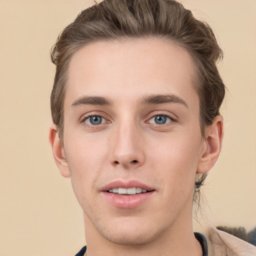 Joyful white young-adult male with short  brown hair and grey eyes