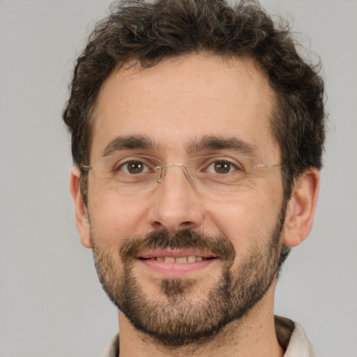 Joyful white adult male with short  brown hair and brown eyes