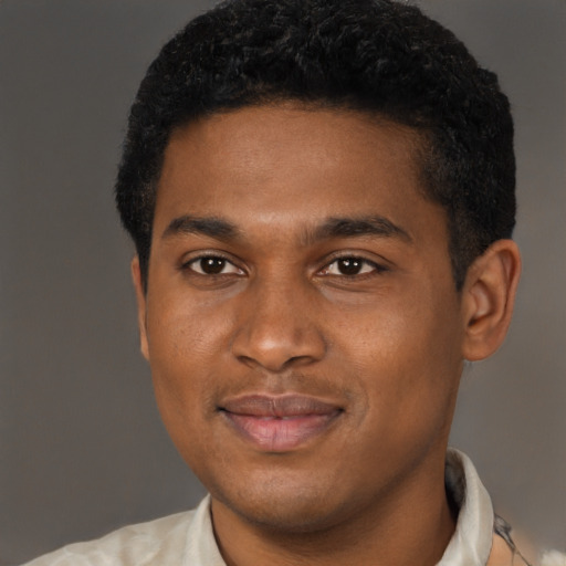 Joyful latino young-adult male with short  brown hair and brown eyes