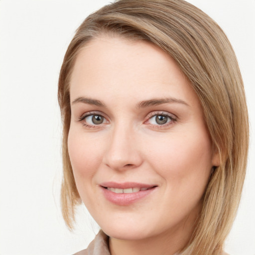 Joyful white young-adult female with long  brown hair and blue eyes