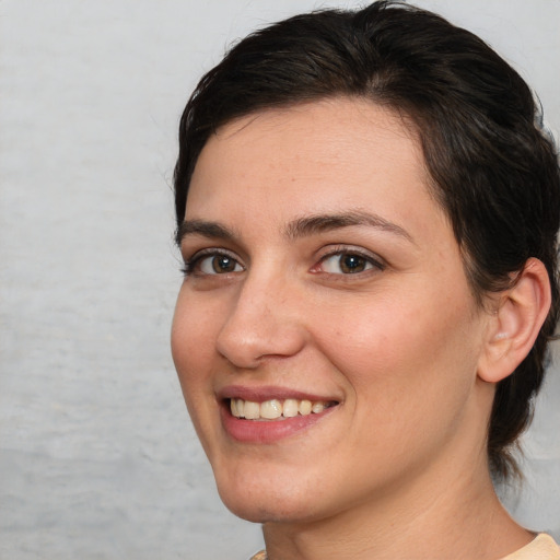 Joyful white young-adult female with medium  brown hair and brown eyes