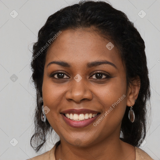 Joyful black young-adult female with long  brown hair and brown eyes