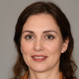 Joyful white young-adult female with medium  brown hair and brown eyes