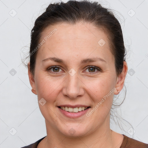 Joyful white adult female with short  brown hair and grey eyes