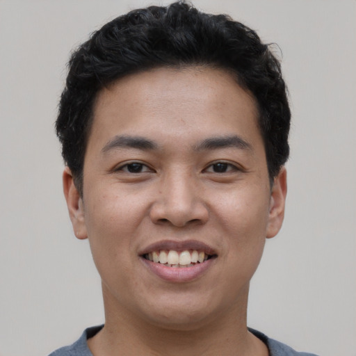 Joyful asian young-adult male with short  black hair and brown eyes