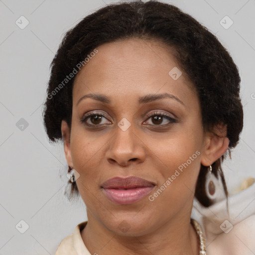 Joyful black adult female with medium  brown hair and brown eyes