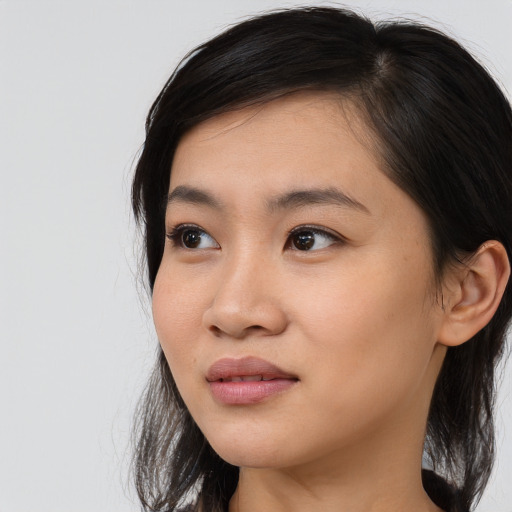 Joyful asian young-adult female with medium  black hair and brown eyes