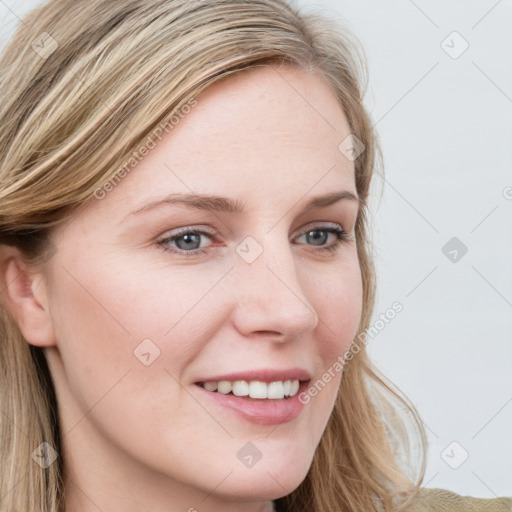 Joyful white young-adult female with long  brown hair and blue eyes