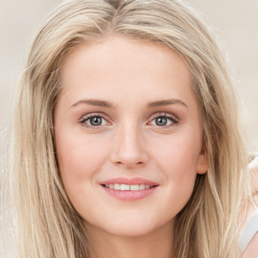 Joyful white young-adult female with long  brown hair and blue eyes