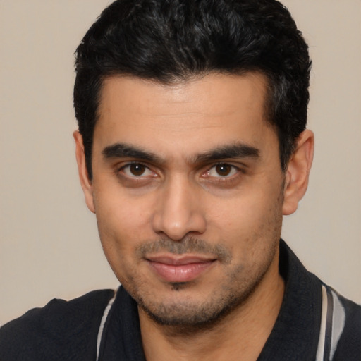 Joyful latino young-adult male with short  black hair and brown eyes