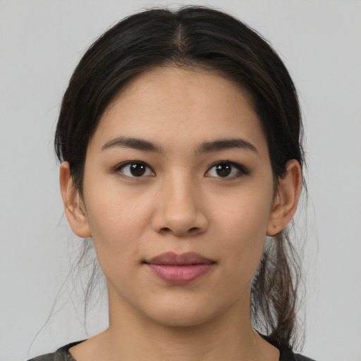 Joyful latino young-adult female with medium  brown hair and brown eyes