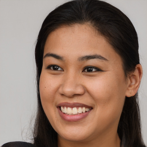 Joyful asian young-adult female with long  brown hair and brown eyes