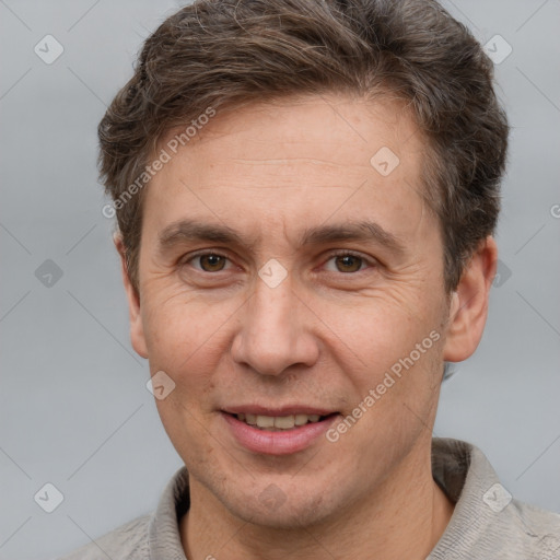 Joyful white adult male with short  brown hair and brown eyes