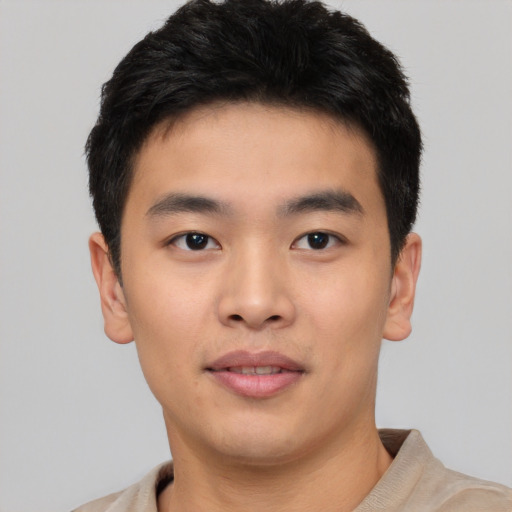 Joyful asian young-adult male with short  brown hair and brown eyes