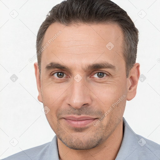 Joyful white adult male with short  brown hair and brown eyes