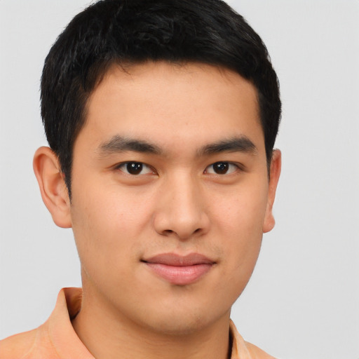 Joyful asian young-adult male with short  brown hair and brown eyes