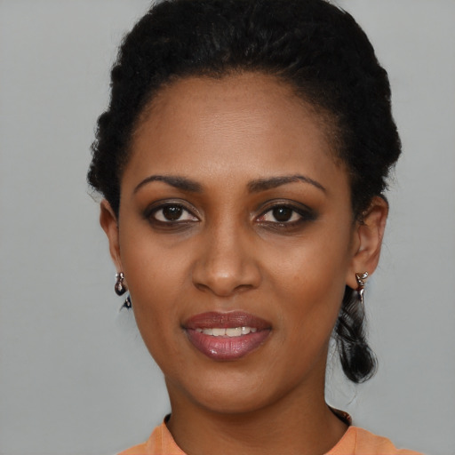 Joyful black young-adult female with short  black hair and brown eyes