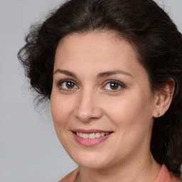 Joyful white adult female with medium  brown hair and brown eyes