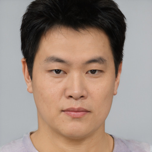 Neutral asian young-adult male with short  brown hair and brown eyes