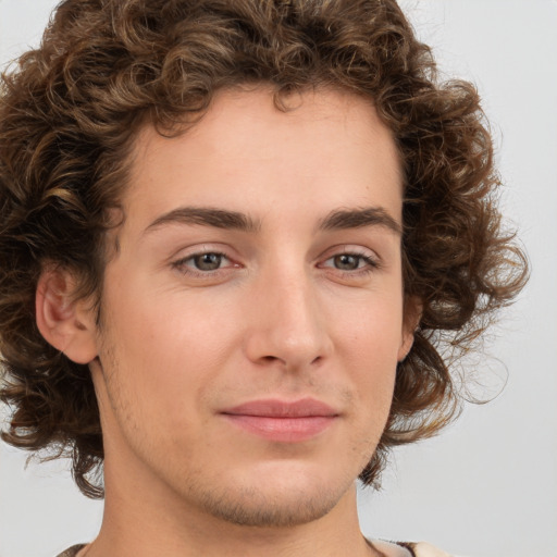 Joyful white young-adult male with medium  brown hair and brown eyes